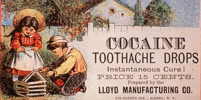 an old advertisement for cocaine toothache drops for 15 cents, featuring two very young children playing outside.